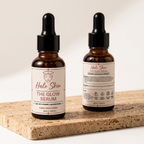 Two bottles of Halo Skin The Glow Serum on a wooden surface with a neutral background vitamin c 